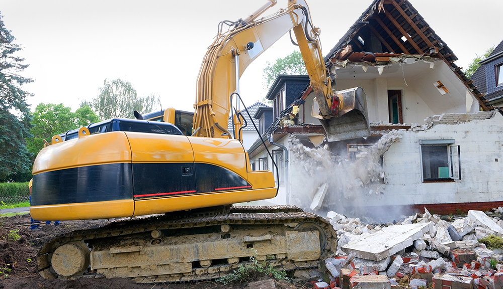 Digger Demolishing House