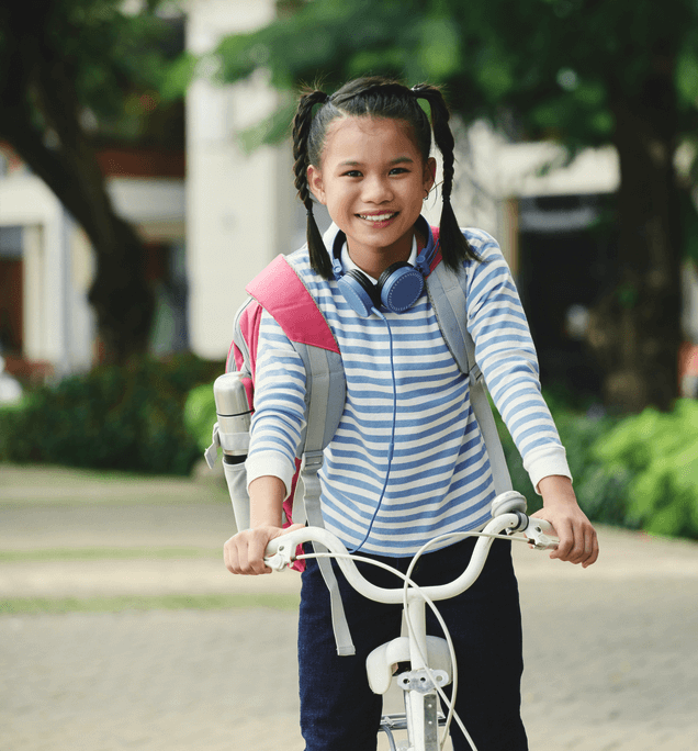 Girl on bike with backpack and earphones