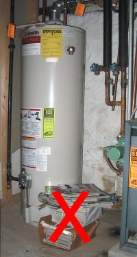 Waterheater with stack of papers next to it