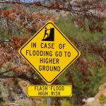 Close up of in case of flooding go to higher ground sign