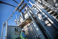 Male crew member checking substation equipment